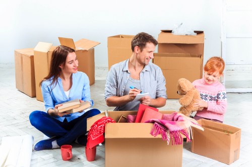 Moving team with van preparing items safely for transport