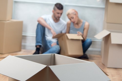 Local moving team preparing packed boxes for transport in West Wickham