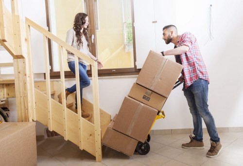Removal team carrying furniture from a residential property in West Wickham